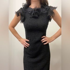 Black fitted dress with ruffles on neckline and shoulders